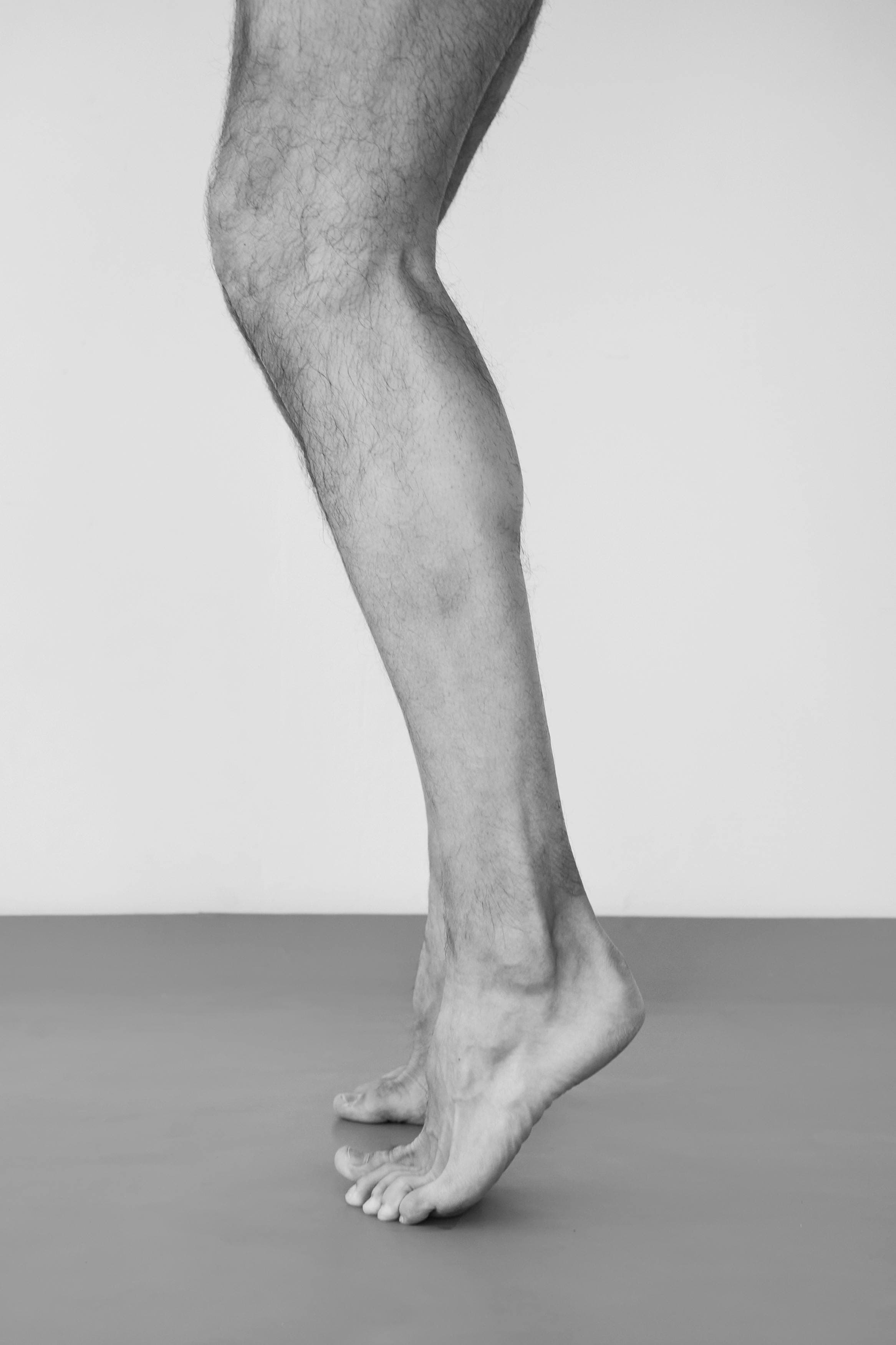 Person performing standing calf raises to build calf muscles