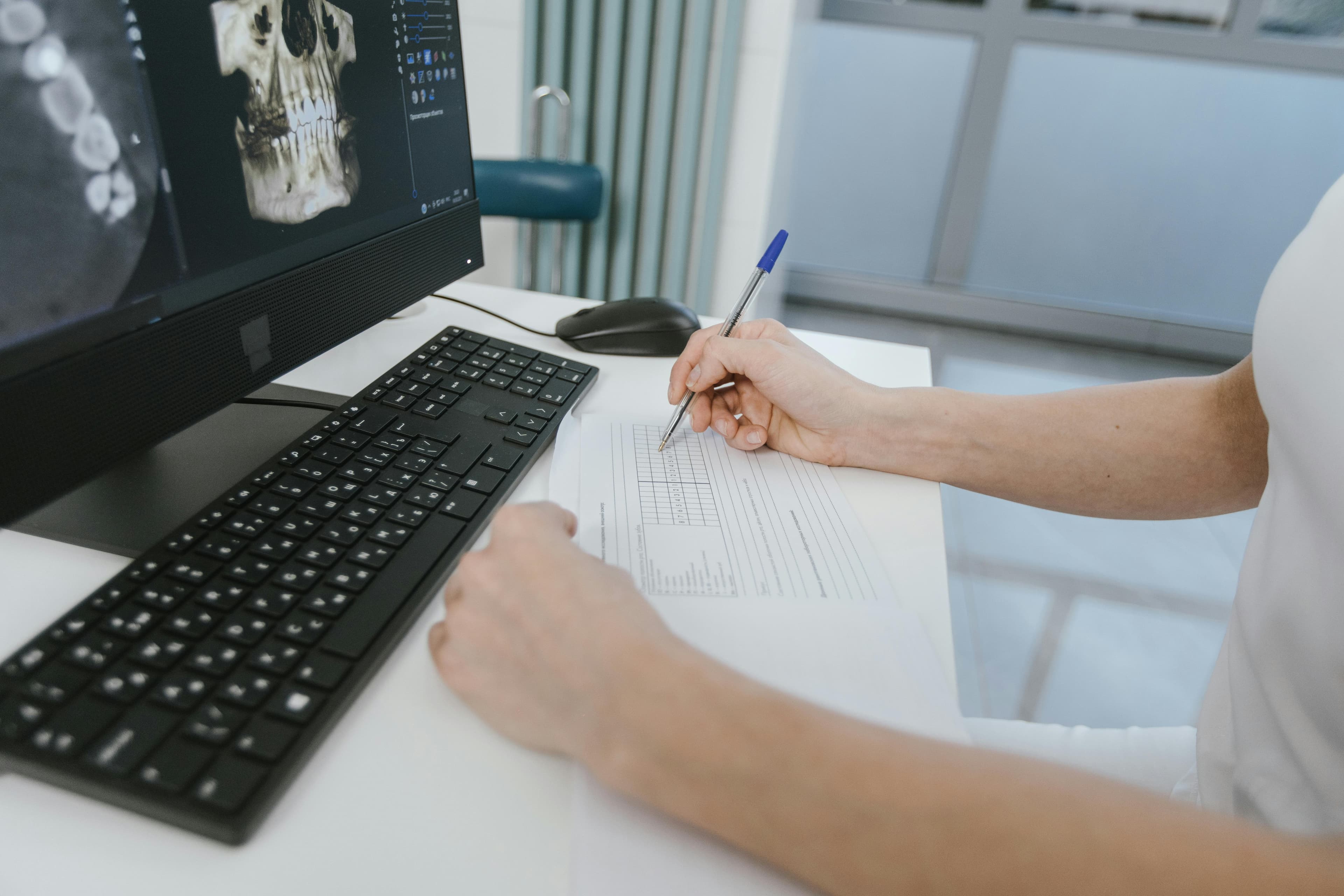 A hepatologist examining liver scan results in a medical office
