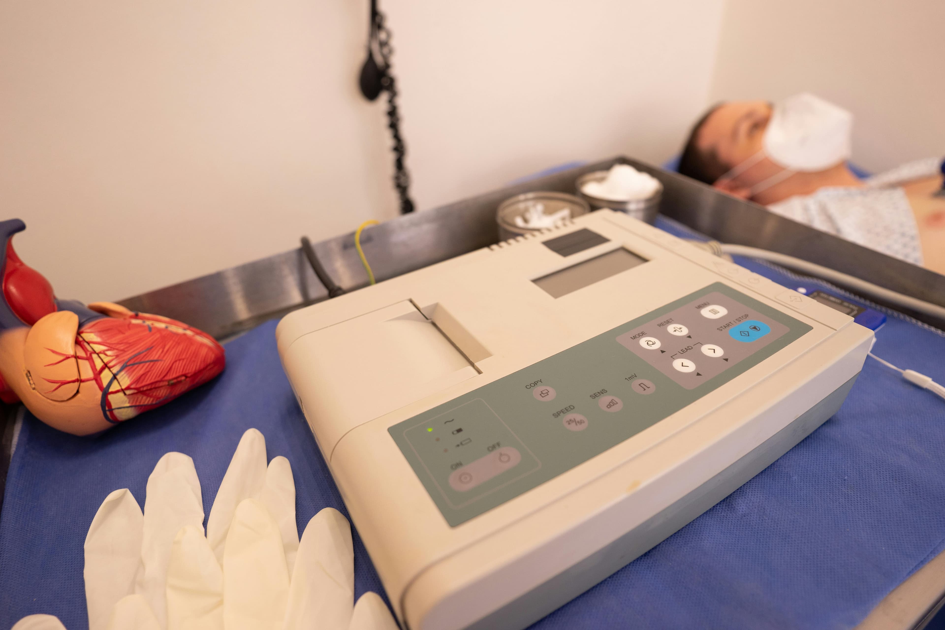 Medical equipment including oxygen mask and monitoring devices in a hospital setting