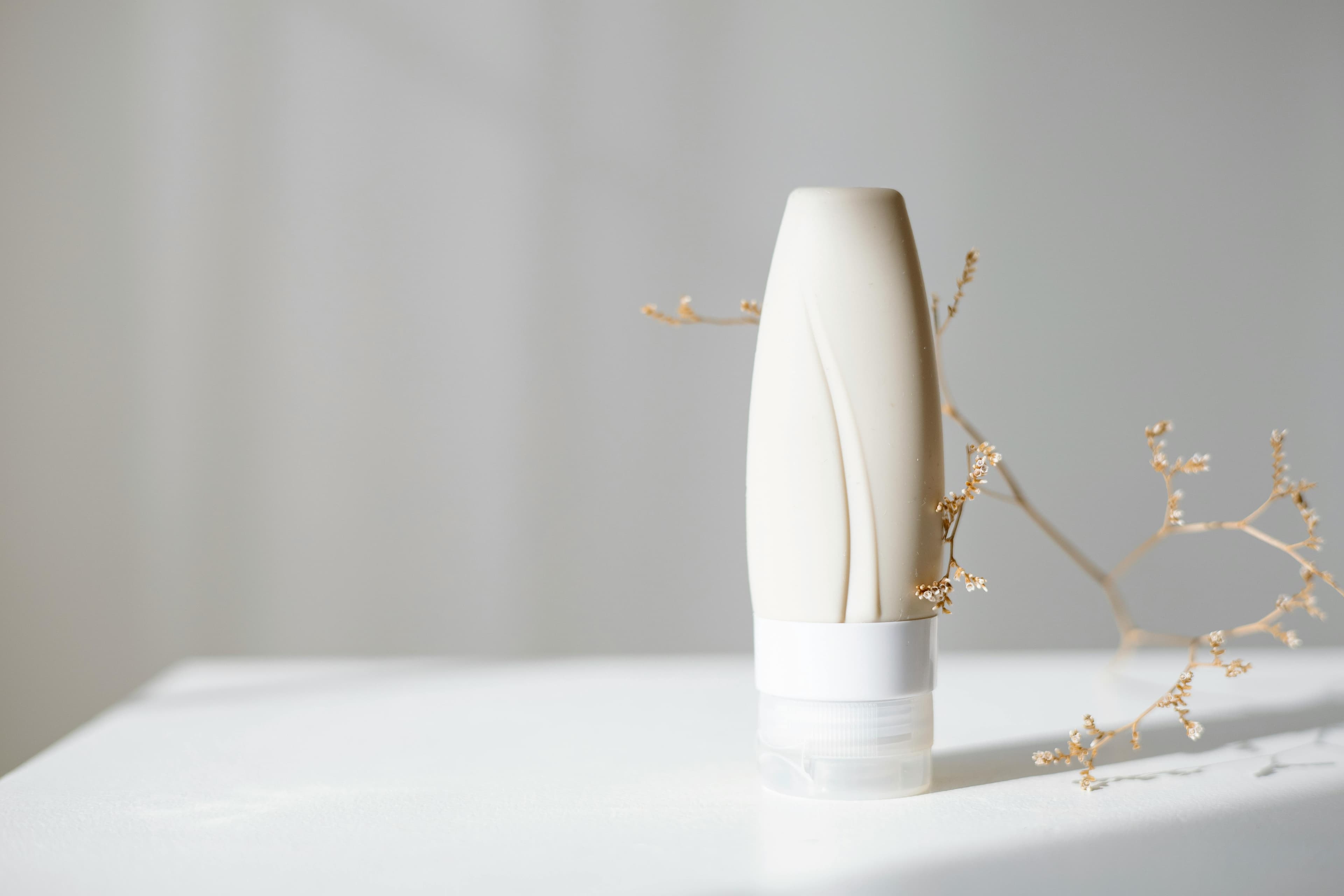 A tube of anal bleaching cream next to natural ingredients used in skin lightening products