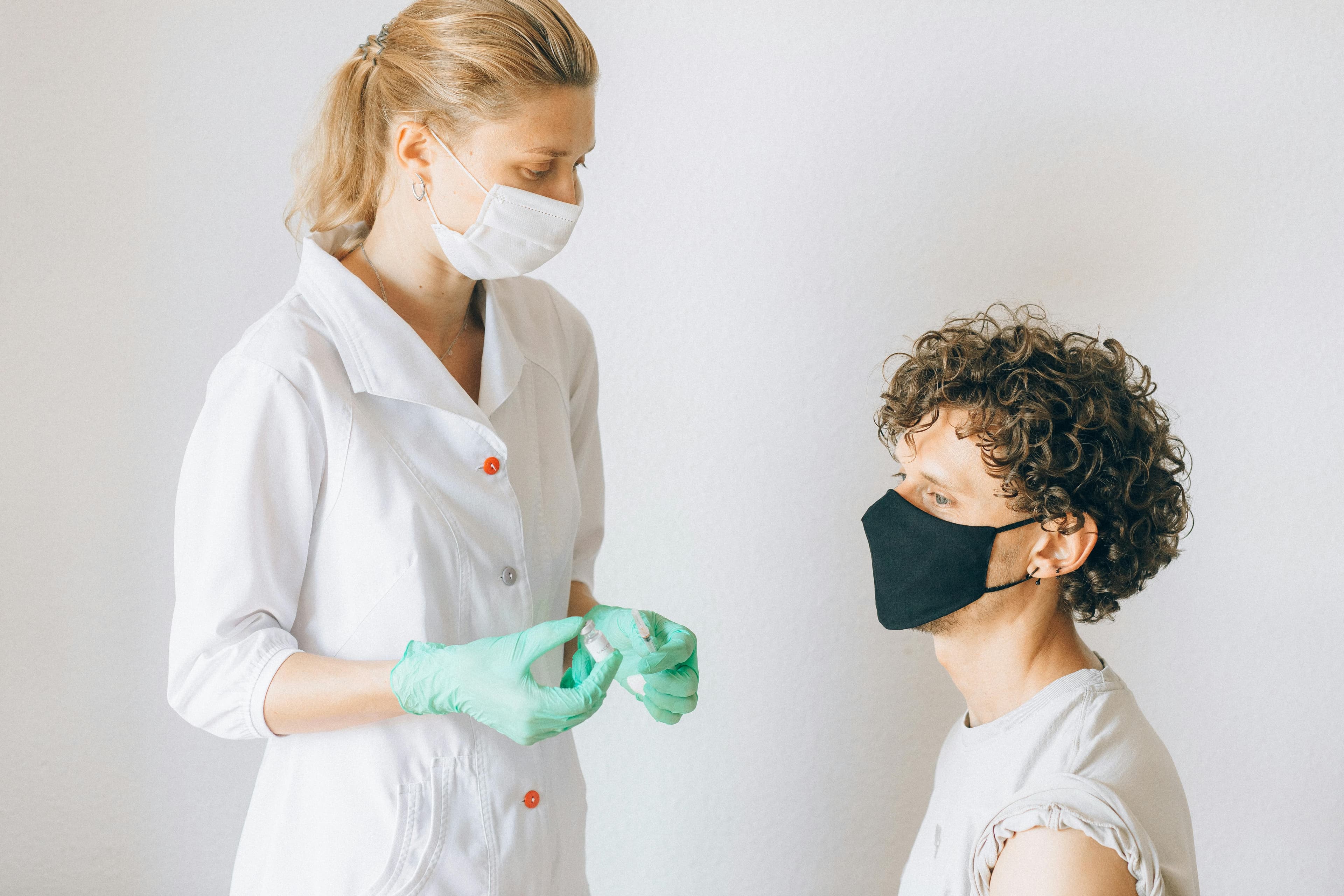 A medical professional preparing an HCG injection