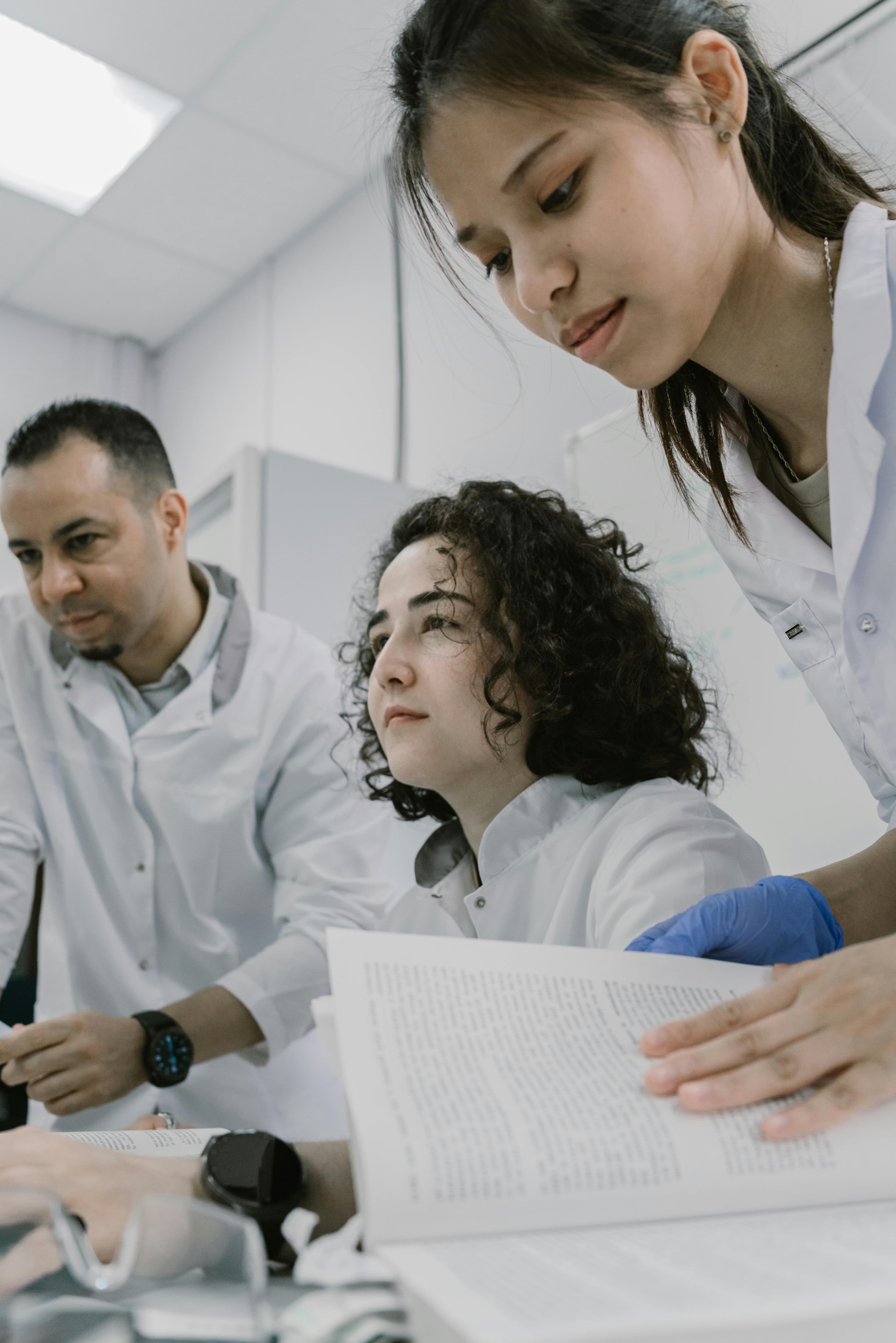 A diverse team of researchers working in a modern medical laboratory