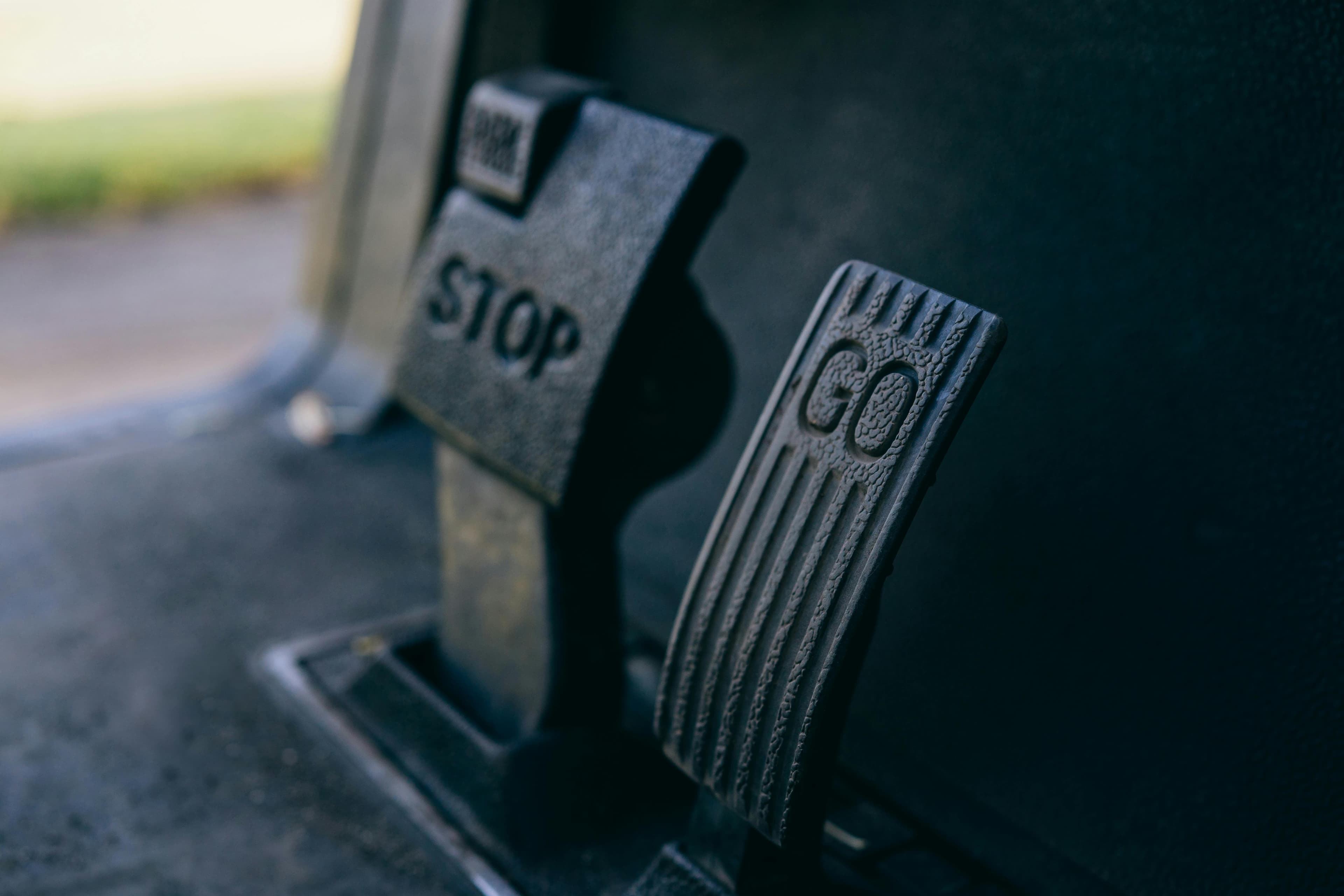 Close-up of a foot pressing a brake pedal in a car