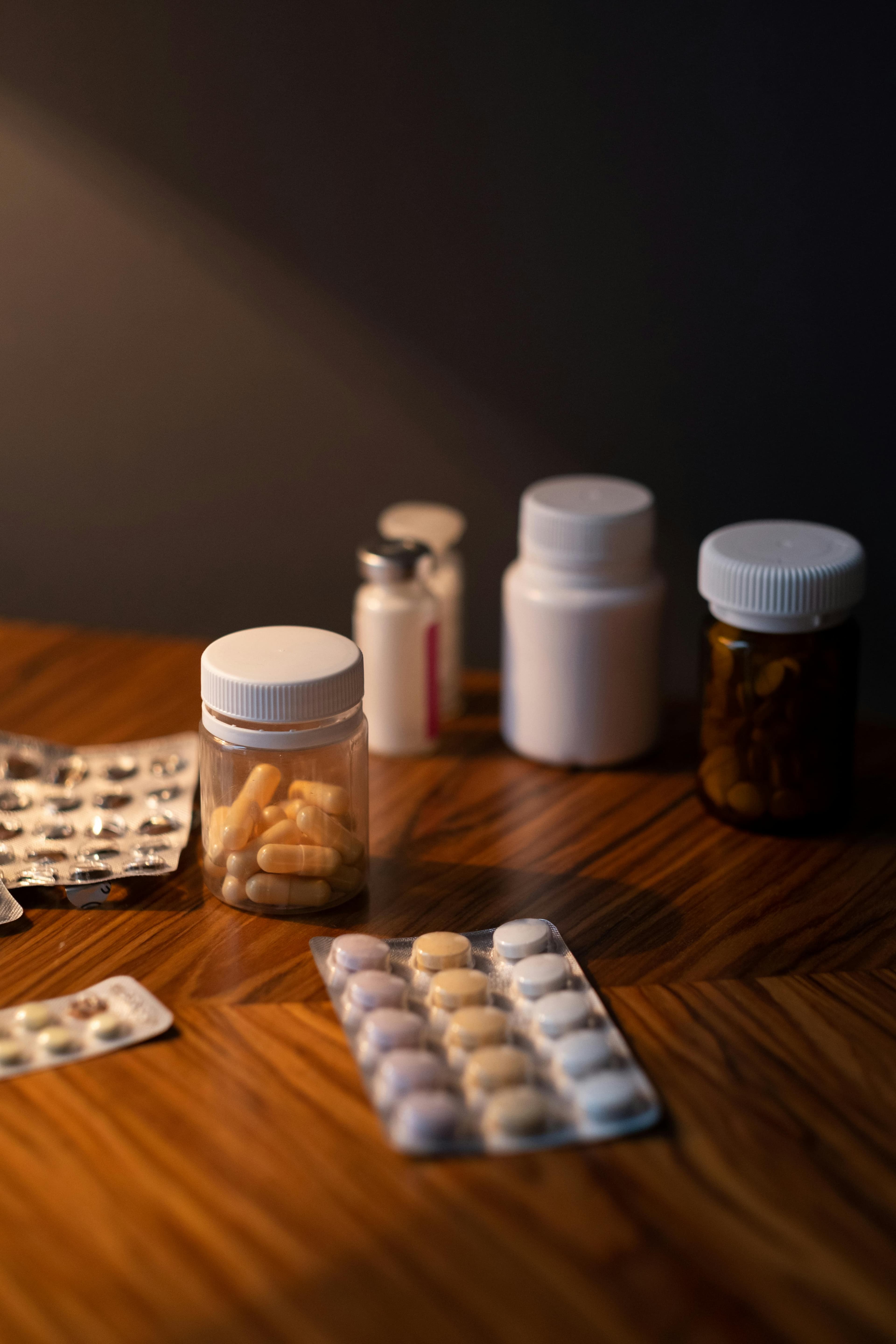 Rows of medication bottles on pharmacy shelves, representing the variety of prescription drugs available
