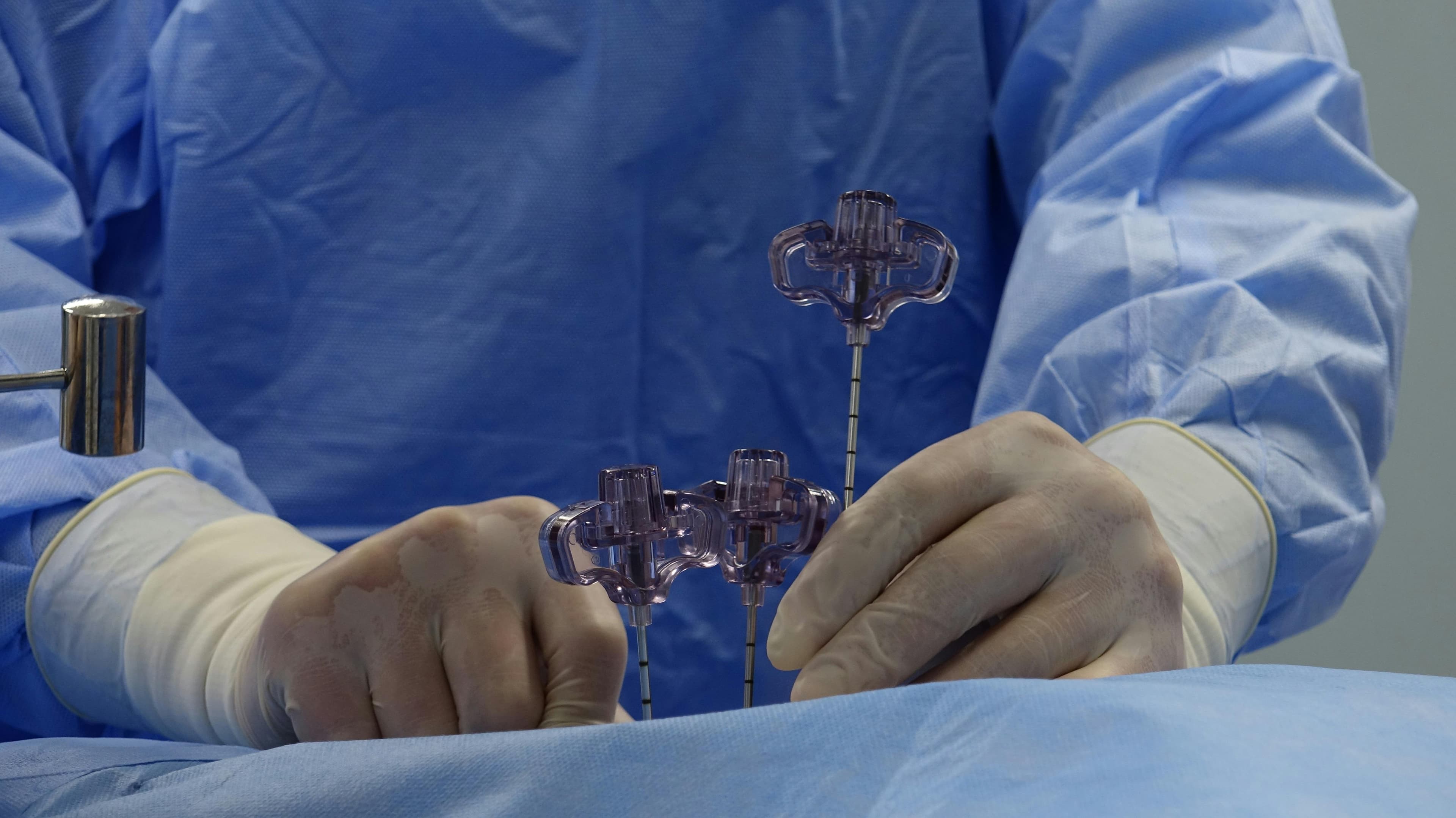 Surgeon performing arthroscopic shoulder surgery with specialized instruments and camera
